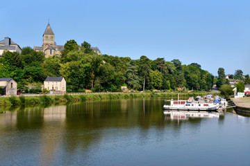 Wall Mural - Port on Mayenne river at Château-Gontier with the Saint-Jean-Baptiste church in height, commune in the Mayenne department, Pays de la Loire Region, in north-western France