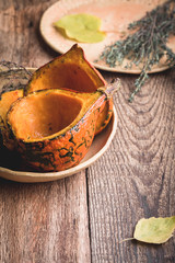 Wall Mural - Baked pumpkins with thyme on rustic table