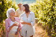 © luckybusiness - Traditional countryside vineyard. mother and daughter on autumn vineyard tasting wine.