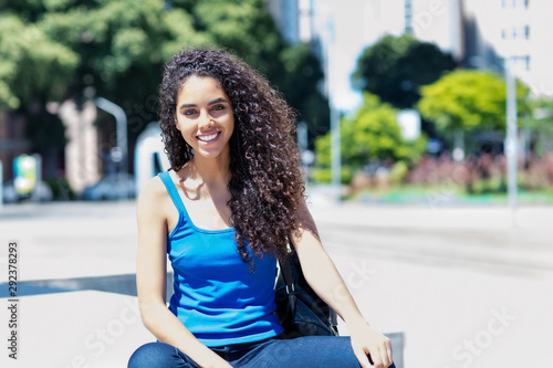 Laughing brazilian young adult woman in city Poster Mural XXL