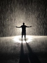 Silhouette Of Man Under Indoor Rain