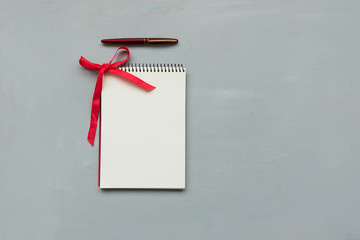 Notebook with to do list on gray wooden background. Christmas planning concept. Flat lay. Top view. Copy space. Mock-up
