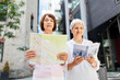 © Syda Productions - tourism, travel and friendship concept - happy senior women with city guide and map on tallinn street