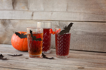 Halloween drinks. Still life on aged wooden background.