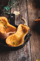 Wall Mural - Baked pumpkins with thyme in cast iron skillet