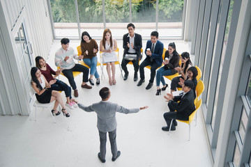 Seminar group, Successful young Asian business man and woman, the man speaker presenting to employees, business coach giving presentation to clients in meeting room, team leader reporting about work.