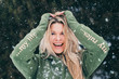 Scandinavian blonde laughing outdoors in snowfall
