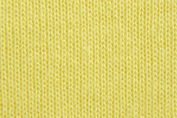 Wall Mural - yellow knitted background. jersey texture. closeup