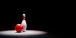 Skittle with Bowling Ball Spotlighted on Black Background