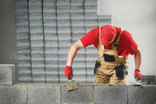 Bricklayer Builder Working With Ceramsite Concrete Blocks. Walling