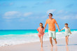 © travnikovstudio - Happy beautiful family of dad and kids on white beach