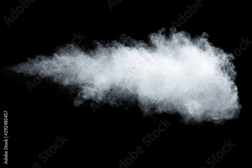 White powder explosion isolated on black background.White dust particles splash.