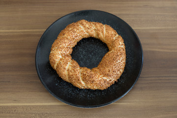 Turkish pastry products are Pogaca, Simit at patisserie on the wooden background.