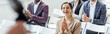 © LIGHTFIELD STUDIOS - panoramic shot of attractive businesswoman smiling and clapping during conference