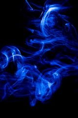 Blue smoke on black background