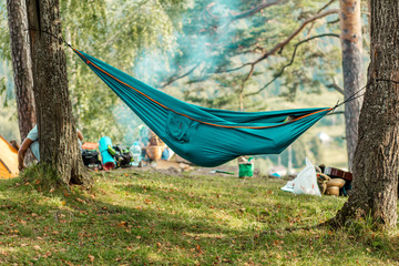 young person resting on the hemmock outdoors, side view photo. relaxation, free time, spare time, lifestyle