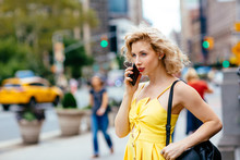 Young Woman Talking On The Phone Outside On The Street In New York City, USA