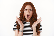 Outraged Upset Angry Redhead Girl In Striped T-shirt, Wristwatch Furrow Eyebrows, Open Mouth Ambushed And Frustrated, Raise Hands In Dismay, Standing Disappointed And Concerned White Background