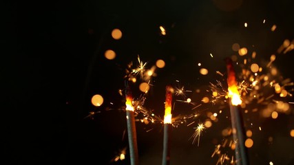 Wall Mural - Super slow motion of burning sparklers on black background. Filmed on high speed cinema camera, 1000fps.