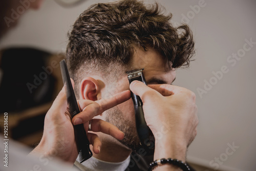 Young Man With Trendy Haircut At Barber Shop Barber Does