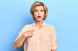 Closeup up portrait of unhappy , angry, annoyed young woman, asking question whats problem, you talking to, mean me Isolated blue background. Negative human emotions, facial expressions reaction