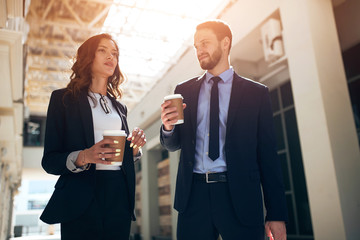 Wall Mural - good looking young ambitious woman expressing her point of view on the problem while handsome bearded man is standing and listening to her very attentively