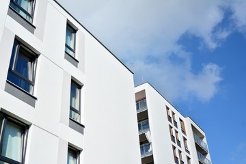 Modern luxury urban apartment building exterior with blue sky