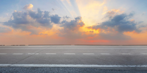 Wall Mural - Empty highway asphalt road at sunrise and twilight sky background