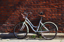Old Bicycle Leaning On A Wall