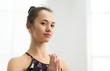 © Prostock-studio - Beautiful woman practising yoga, holding hands in namaste