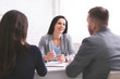 © Prostock-studio - Professional woman talking to young couple at personal meeting