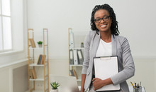 Business Girl Holding Folder Smiling At Camera In Office