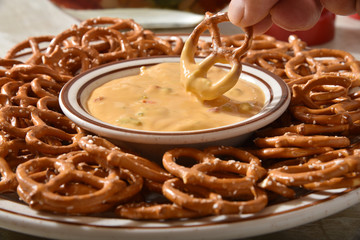 Poster - Dipping a pretzel in cheese sauce