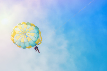 Parachute against the blue sky, an attraction for tourists