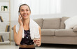 © Prostock-studio - Fit girl talking on phone after exercising at home