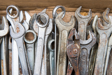 Close up of old, rusty and dirty chrome vanadium wrench (set spanners), pliers, top view.  Workshop hand tools concept