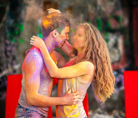 happy young pair in paints holi