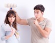 © Elnur - The young family doing renovation at home - painting walls