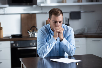 Wall Mural - sad man in shirt sitting at table with ring and divorce documents