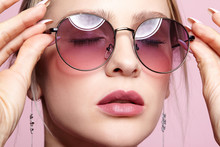 Close-up Portrait Of Attractive Young Woman In Tinted Glasses  And Closed Eyes