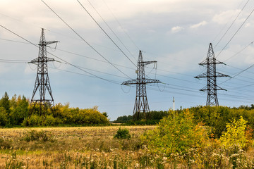 power transmission line poles in the field