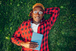 © Nomad_Soul - Black student in glasses reading book on the grass
