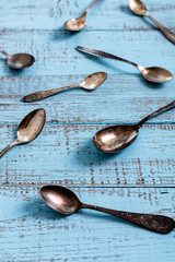 Wall Mural - Vintage cutlery - spoons, forks and knives on an old wooden background.