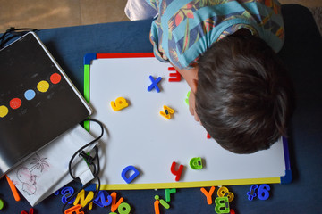 Child playing with magnetic letters