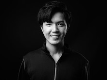 Young Handsome Asian Man Smiling Against Black Background