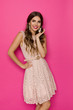 © studioloco - Cute Woman In Beige Lace Mini Dress Against Pink Background