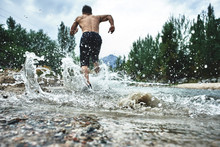 Asian Athlete On A Morning Run On The River, Kazakh Jogger In Nature Close-up