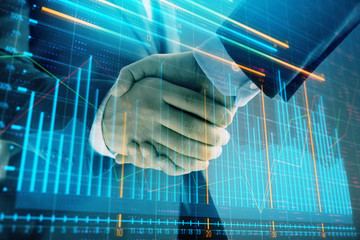 Multi exposure of forex graph on abstract background with two businessmen handshake. Concept of success on stock market