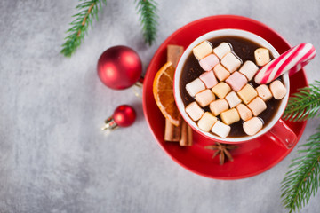 Red cup of hot chocolate with candy cone and marshmallows