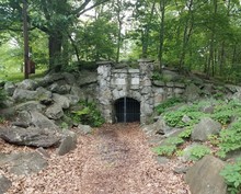 Entrance To Coal Mine With Metal Door And Leaves